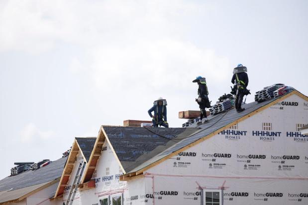 FILE - People work on the roof of a new housing development in Sandston, Va., June 6, 2025. (Mike KRopf/Richmond Times-Dispatch via AP, File)