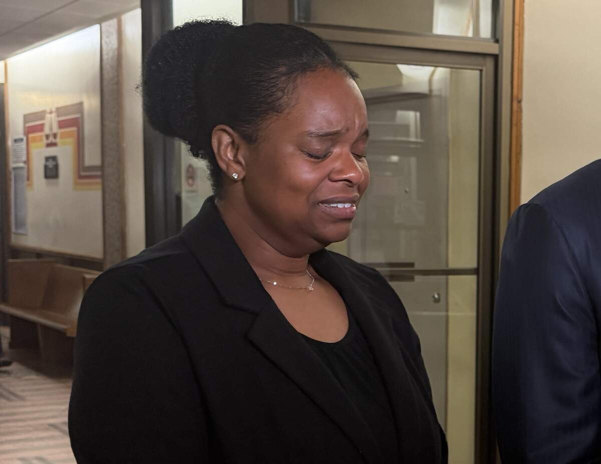 Precious Bland cries as her attorney, Larry Handfield, speaks to reporters outside a Miami courtroom on Tuesday, June 23, 2026.