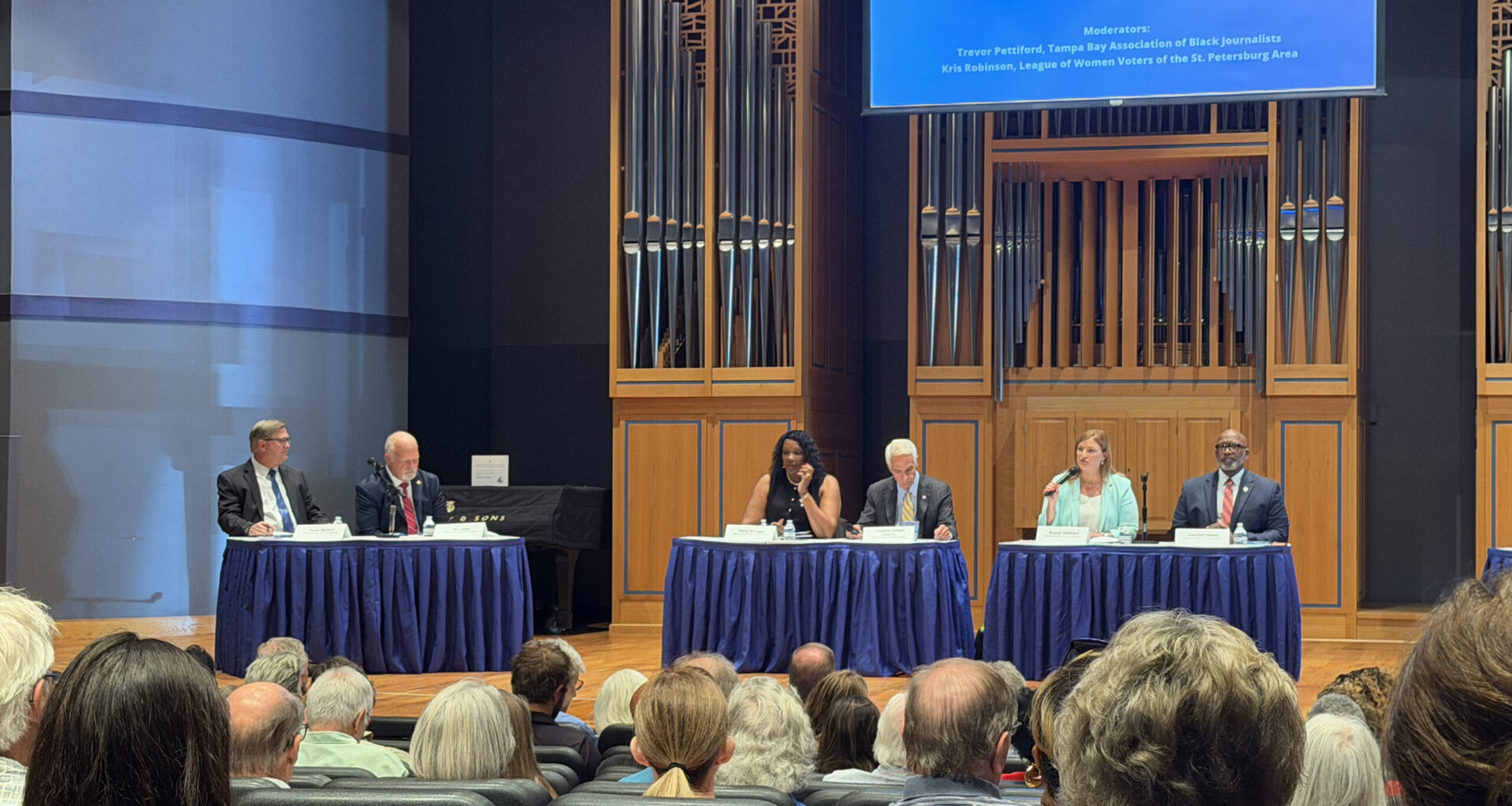 St. Pete Mayoral forum. From left: candidates Kevin Batdorf, Jim Large, Maria Scruggs, Charlie Crist, Brandi Gabbard, and Ken Welch. Photo by Daria Mironova/WMNF.