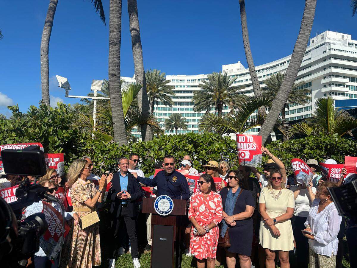 Miami Beach Commissioner Alex Fernandez (center) acknowledges Mayor Steven Meiner during a press conference to oppose state legislation alongside other city officials and residents in front of the Fontainebleau Hotel on March 10, 2026.