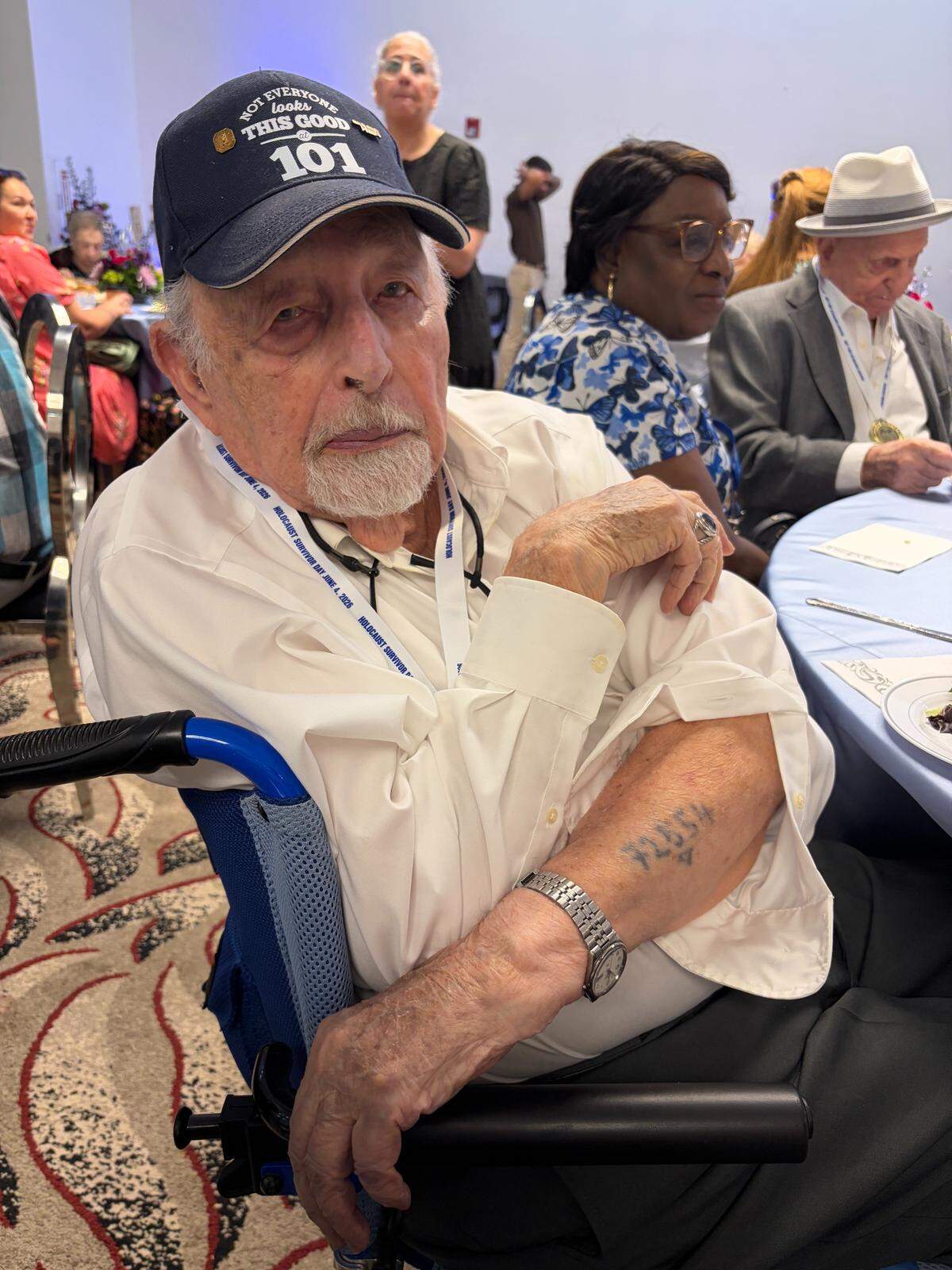 Herman Haller, 101, shows a tattoo of a serial number he was given by Nazis during his time as a prisoner at Auschwitz. Haller attended a celebration in honor of Holocaust Survivor Day hosted by the Goodman Jewish Family Services of Broward County.