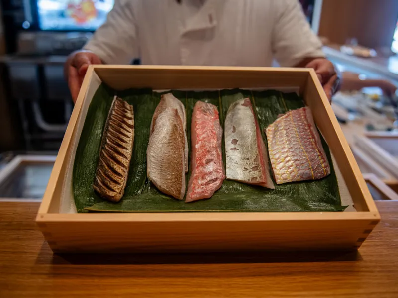 Chefs at Okonomi inside Mills Market shape bites from rare cuts of fish