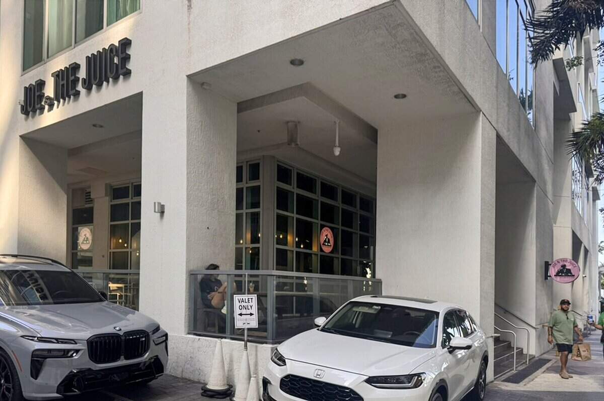 A half-block from the circular foundation of an ancient Tequesta dwelling, a customer sits at the Joe & the Juice café operating at the Met Square development in downtown Miami, Fla., on Sunday, June 28, 2026. Downtown Miami is home to several sites of significant indigenous historical importance, reflecting the region's deep roots long before the city's modern development.