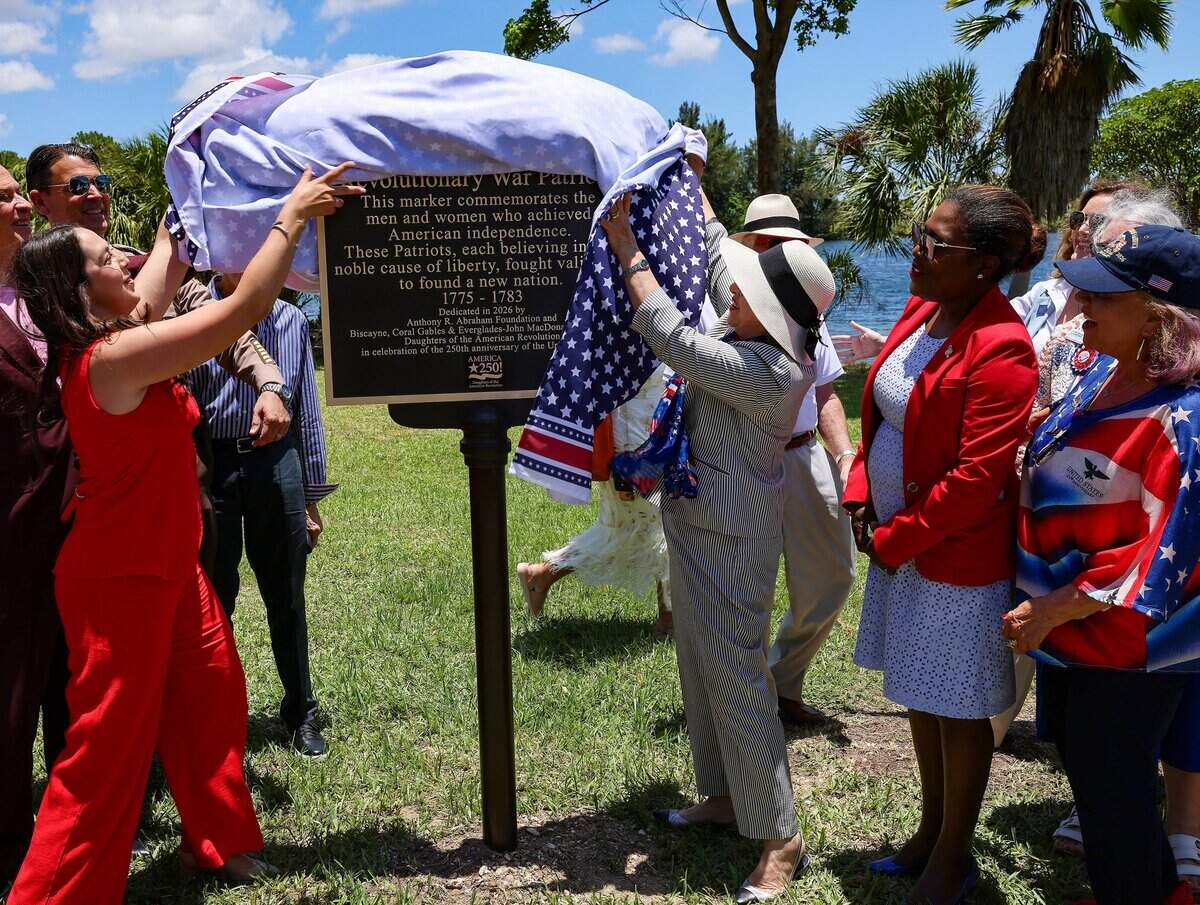 Miami-Dade Commissioner Natalie Milian Orbis, left, and Mayor Daniella Levine Cava, center, join other officials and stakeholders in unveiling the America 250 Patriot Marker at Tropical Park on Monday, June 29, 2026, in Miami-Dade County. The event marked America's 250th anniversary and included the installation of a time capsule.The event celebrated the nation's history and aimed to preserve the present for future generations. The Miami-Dade 250 time capsule will remain sealed for 50 years, to be opened at the tricentennial in 2076, preserving the stories, achievements and cultural spirit of the community.