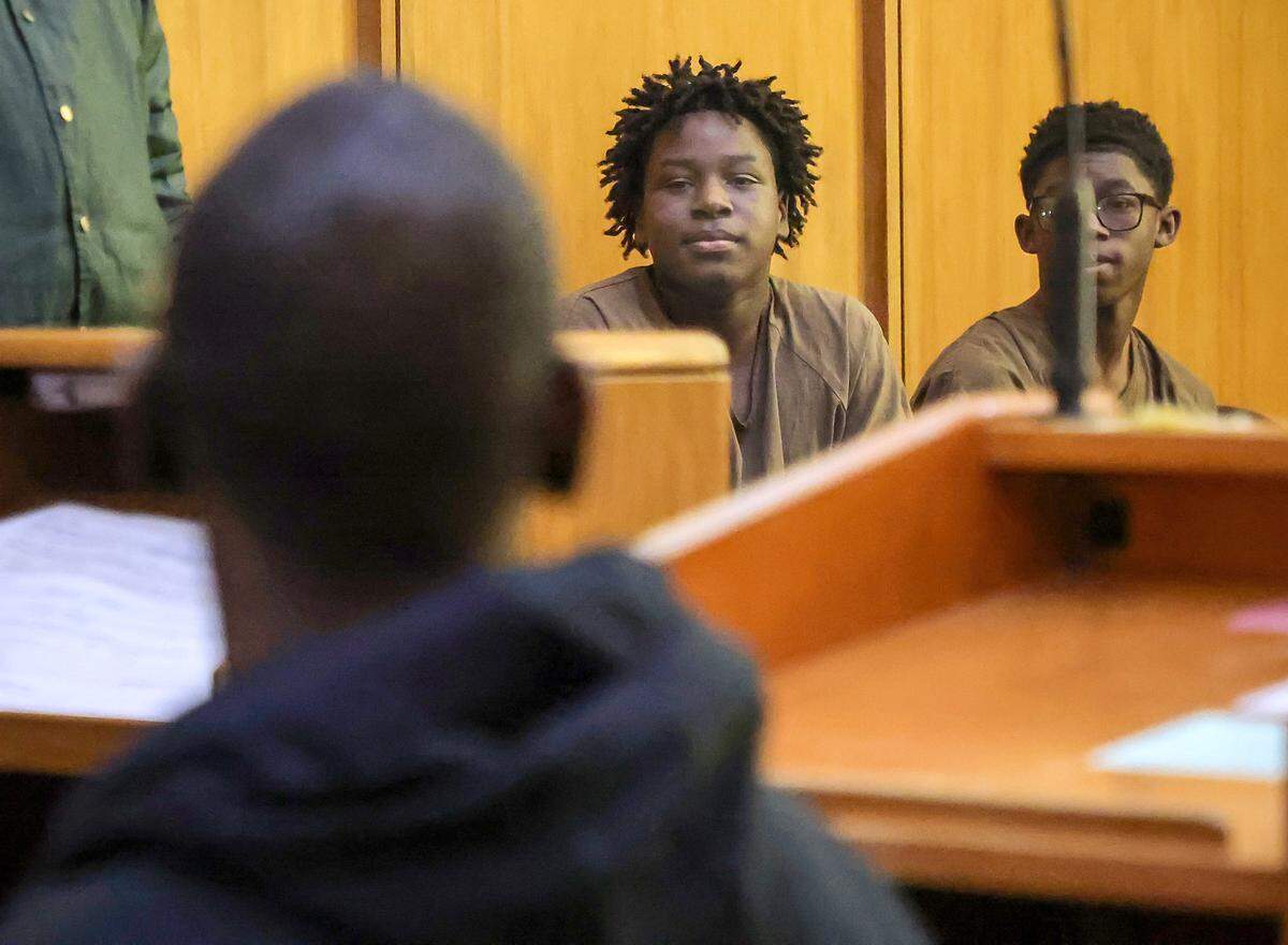 Jusiah Jones, center, looks at his family members while he and Xavier Tyson, right, are present in Judge Richard Hirsch's courtroom 4-8 for their bond hearing. They are two of the three boys charged as adults in the rape of a 12-year-old girl. This hearing took place on Wednesday, March 18, 2026, at the Richard E. Gershwin Justice Building in Miami, Florida.