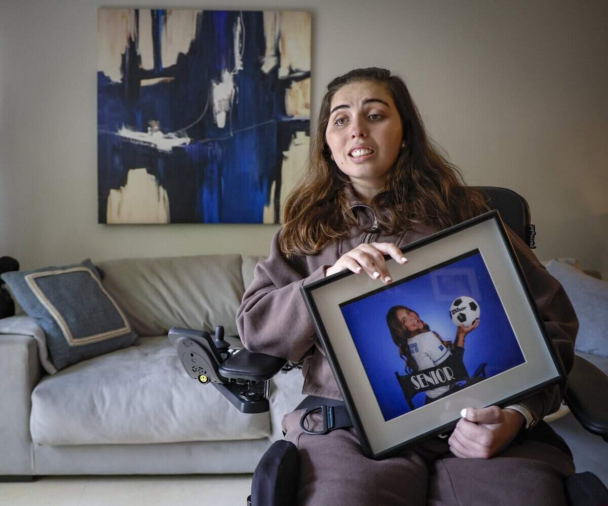 Katerina “Katy” Puig holds a Our Lady of Lourdes Academy senior year portrait at her home in Miami on Wednesday, Oct. 15, 2025. Puig is still recovering from catastrophic injuries she recieved in the boat crash.