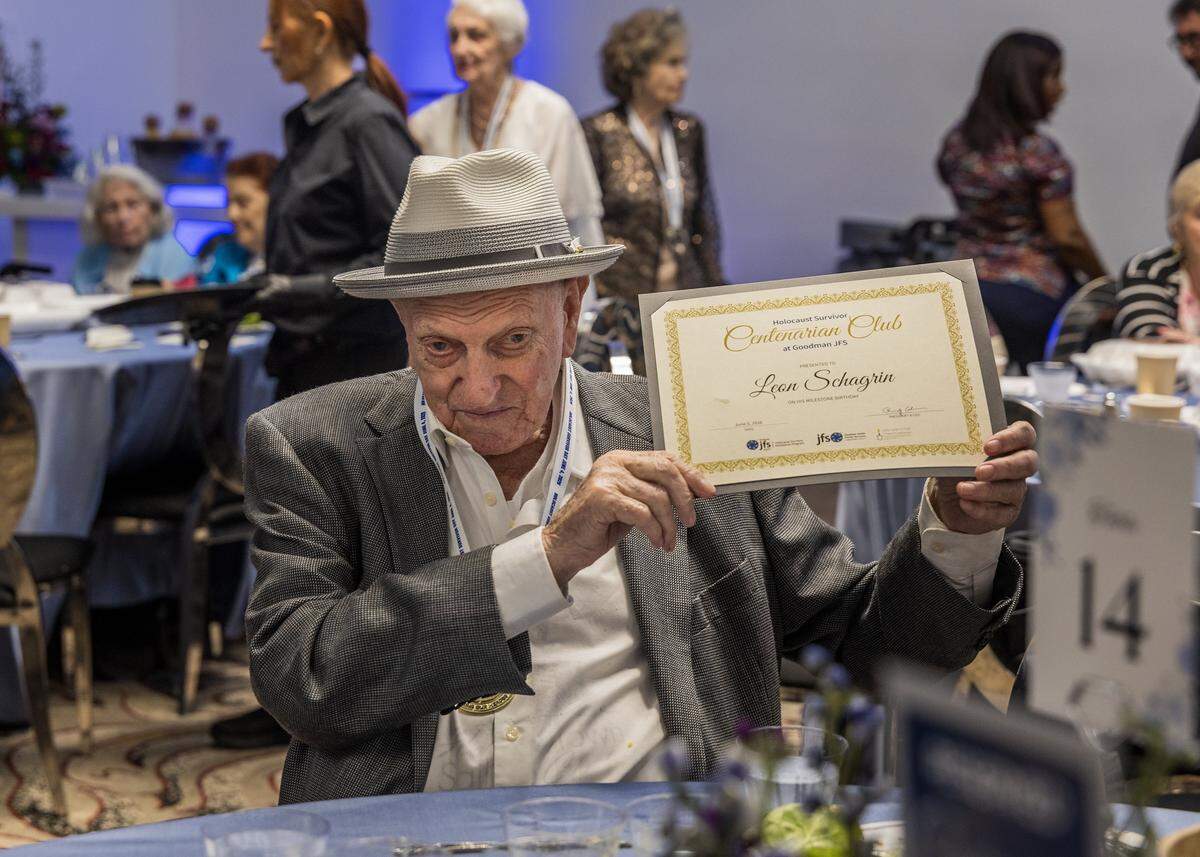 Leon Schagrin, 100, born in Grybów, Poland, holds up a recognition given to him on Holocaust Survivor Day by the Goodman Family Jewish Services. 
