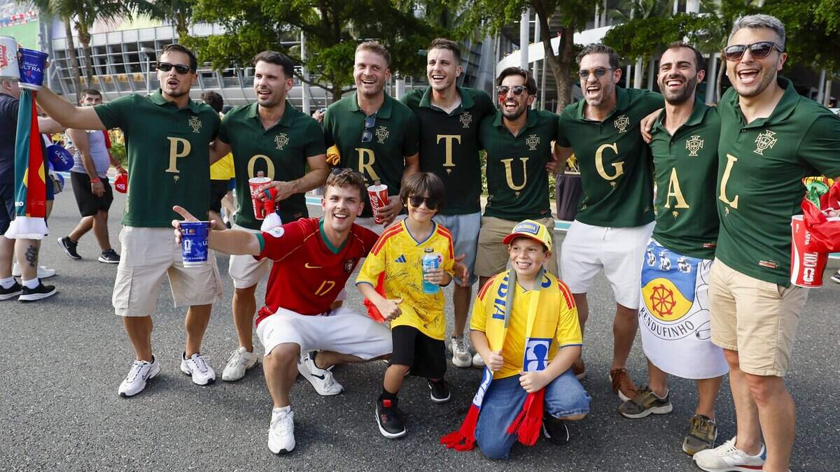 Soccer fans Pereira Gerson, Juan Diego and David Santiago  pose with Portugal team fans as they arrive for the start of the World Cup Group K soccer match beween Colombia and Portugal at Hard Rock Stadium (Miami Stadium) in Miami Gardens, Florida on Saturday, June 27, 2026.