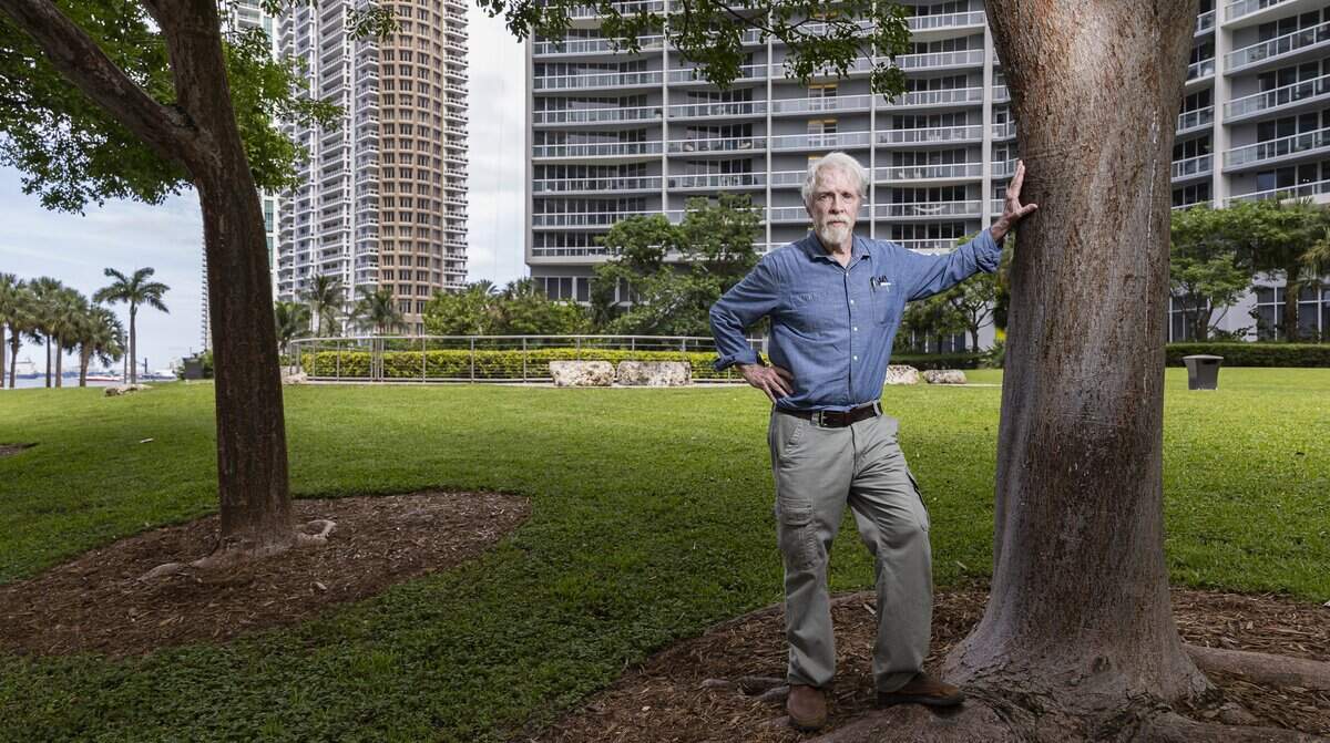 Archaeologist Bob Carr stands near the 2,000-year-old Miami Circle, at center, in a park at the mouth of the Miami River in Brickell. An Icon Brickell tower, built over vestiges of an indigenous village, rises behind the circle. Carr led the excavation of the circle, an arrangement of postholes carved in the limestone bedrock that served as the foundation of a ceremonial building erected by the prehistoric Tequesta people, after its 1998 discovery. The postholes were covered for protection from the elements, and recovered materials and artifacts were sent to the Museum of Miami, where some pieces are on exhibit.
