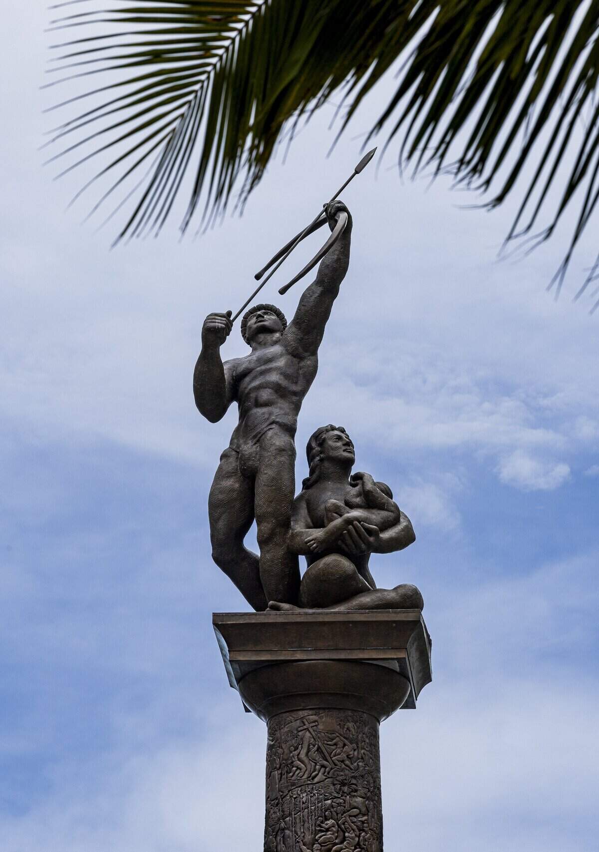 A bronze statue of a Tequesta Indian warrior, his wife and child rises on a column over the Brickell Bridge at the mouth of the Miami River, the site of an extensive prehistoric indigenous town dating back more than 2,000 years. Famed sculptor Manuel Carbonell said the child covers his face because he can’t face the fact of the Tequestas’ extinction.
