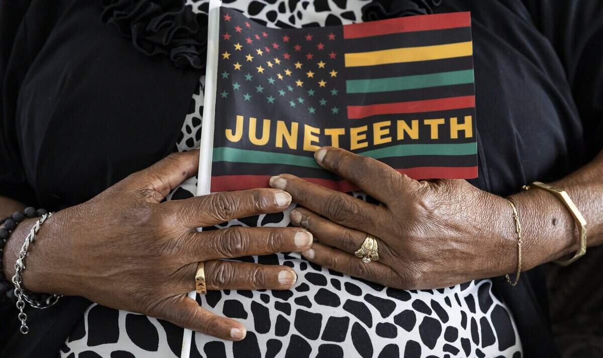 Barbara Williamson, 85, holds a Juneteenth flag at her home on Thursday, June 18, 2026, in Fort Lauderdale, Fla. Williamson participated in sit-ins and fought for passage of the Voting Rights Act of 1965.