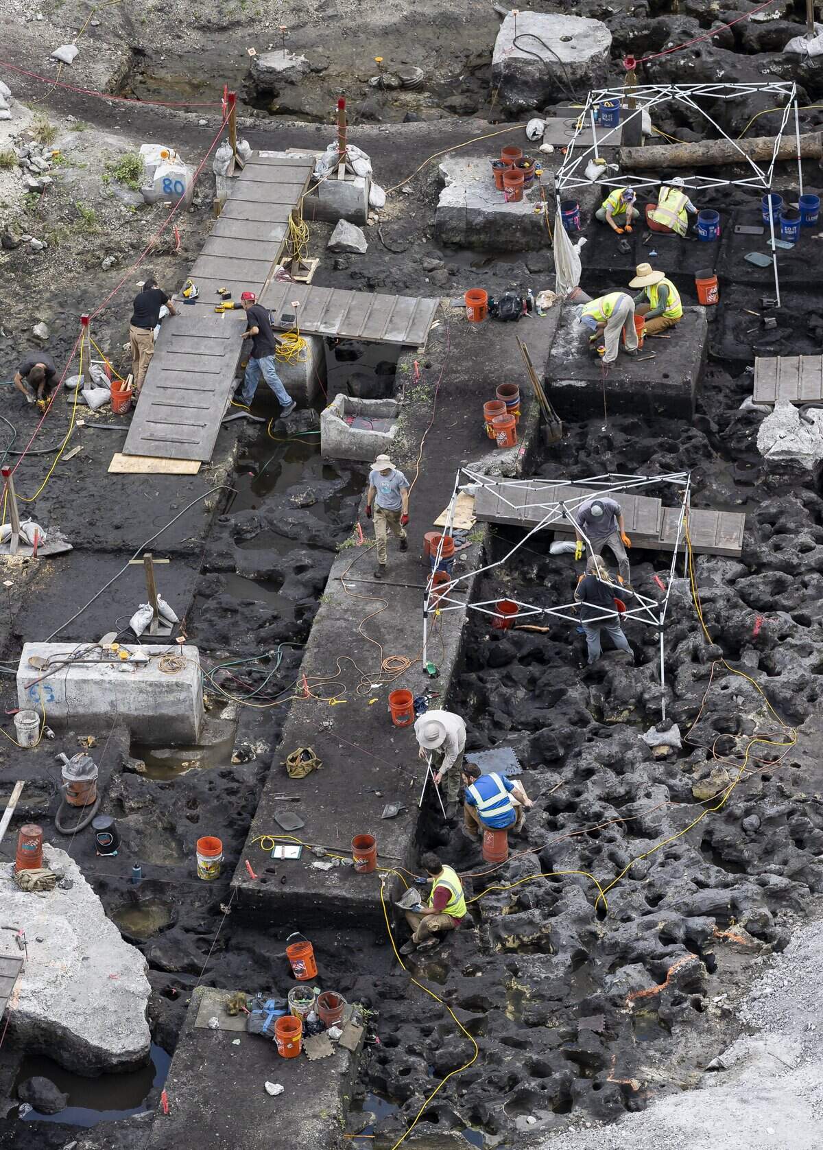 Archaeologists work at the site of a prehistoric indigenous village on the Miami River in Miami’s Brickell district in 2023. The excavation uncovered foundation holes for dwellings, gravesites, human remains, artifacts and other evidence of extensive long-term settlement by the Tequesta people.