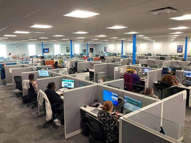 Workers at a Medicaid call center in Jefferson City, Missouri, field questions.