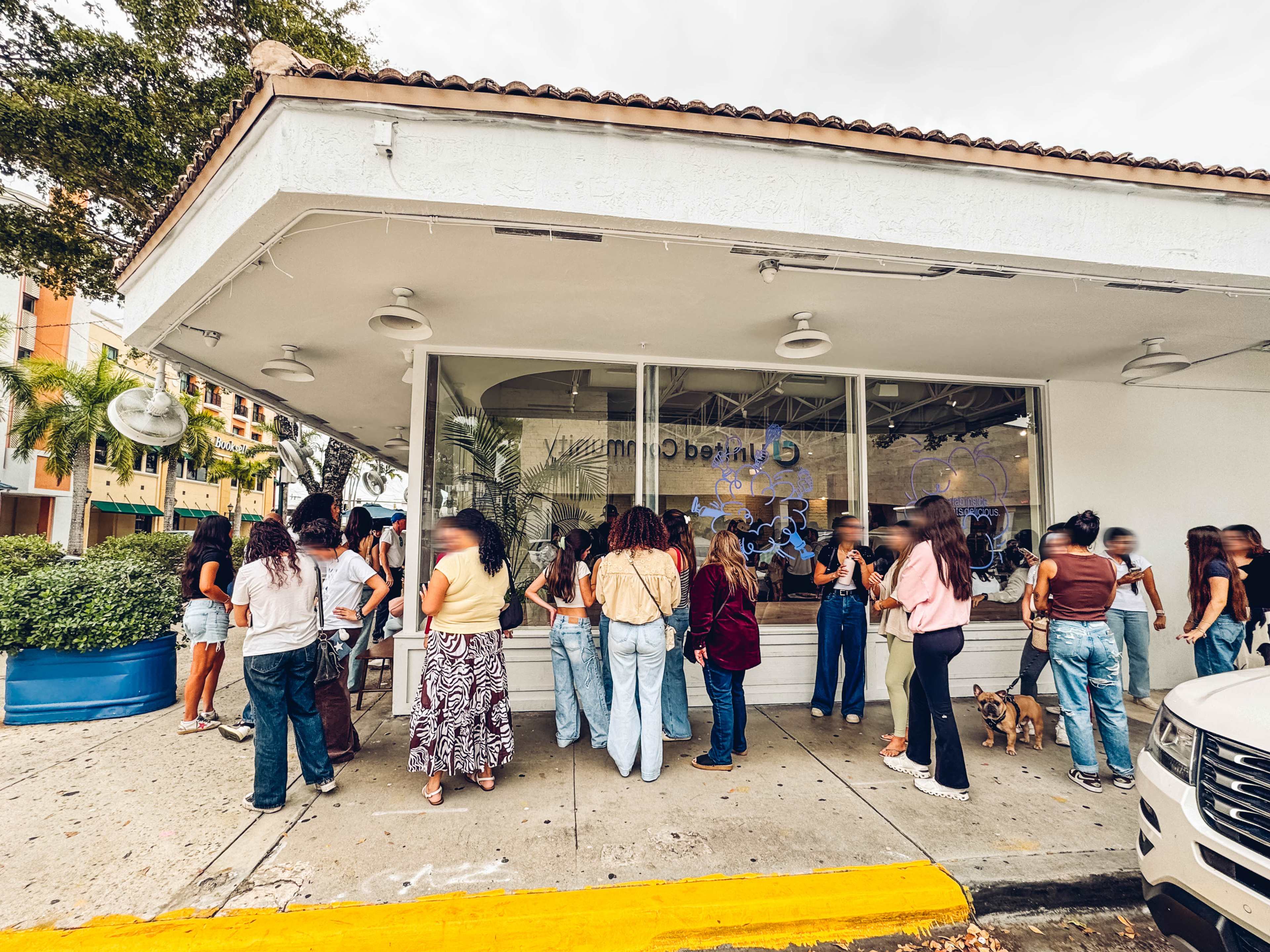 Exterior of cafe with a line