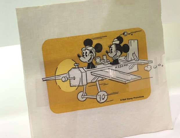 A display of a Mickey Mouse cocktail napkin used on Walt Disney's Grumman Gulfstream I company plane during the D23 Expo at the Anaheim Convention Center. (Photo by Brady MacDonald, Orange County Register/SCNG)