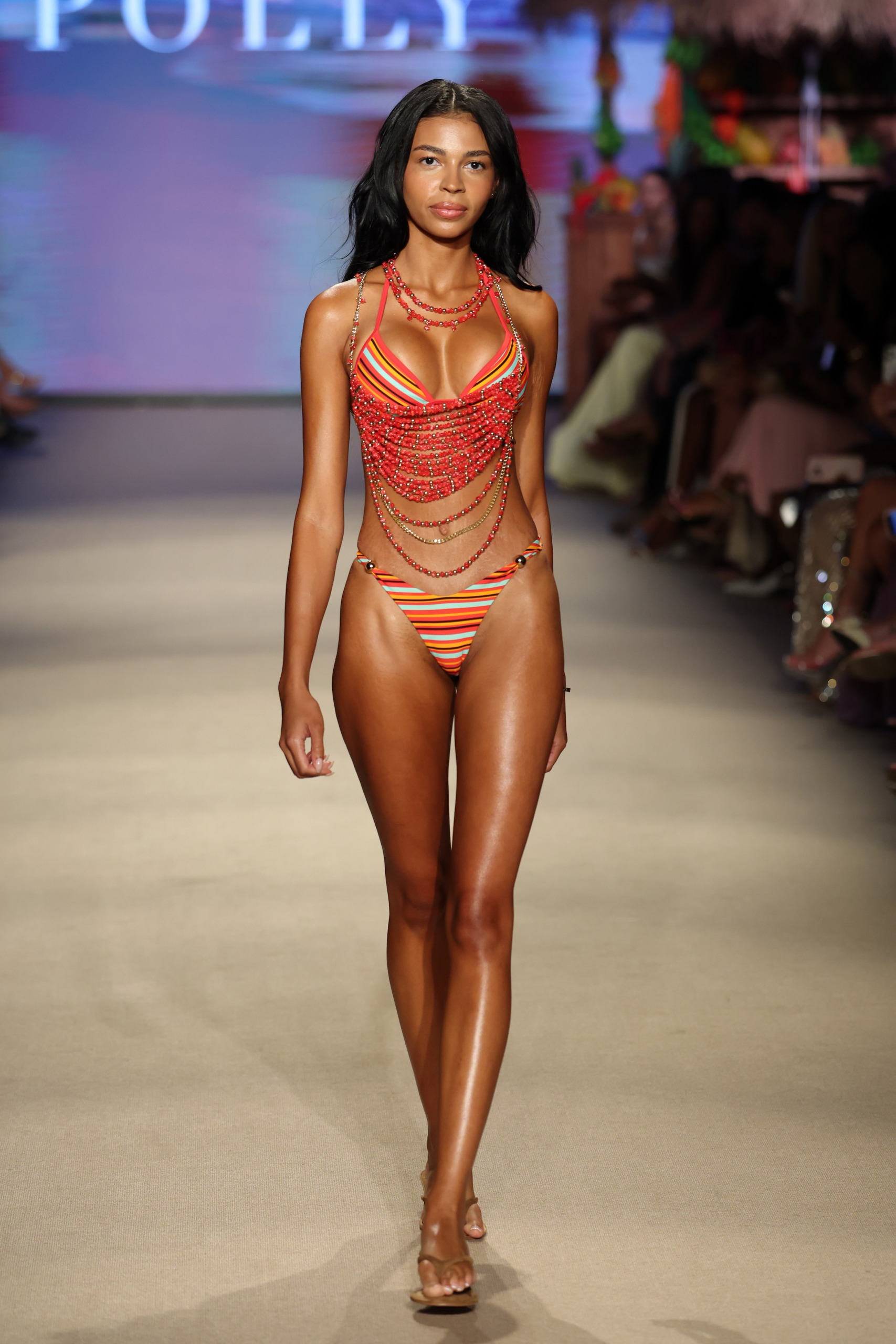 Layla Taylor in Oh Polly Runway during Paraiso Miami Swim Week 2026 wearing a red and orange look with beaded accents