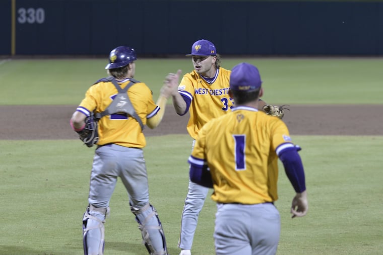 West Chester pitcher Kyle Lazer (center), who pitched a complete game, is congratulated by catcher Caleb Strawhecker (left) after the final out against Tampa on Friday in Cary, N.C.
