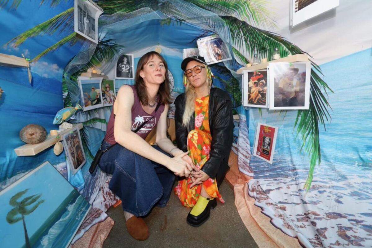 Patty Gone and Kelly Breez inside the installation of the giant margarita surrounded by Breez’s found object art.