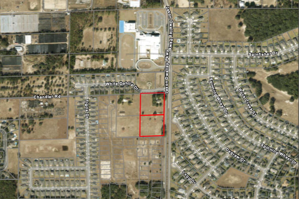 An aerial map from city planning documents outlines the 5.12-acre site at 4410 and 4420 Chandler Road (outlined in red), where an applicant is seeking a future land-use change and rezoning to allow development of the proposed Joy Child Academy child care facility.