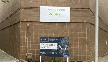 A sign on a building announces that Publix is coming soon.