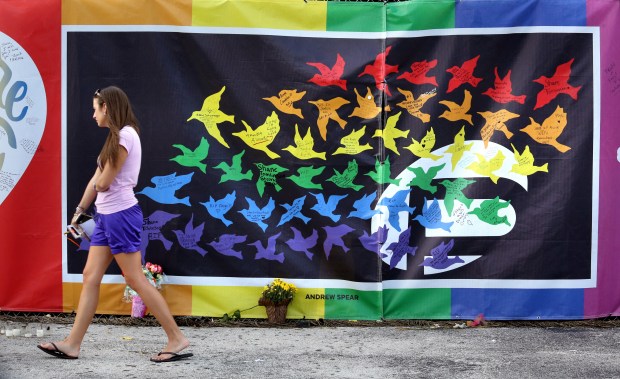 A banner by Orlando artist Andrew Spear adorned the security fence erected around the Pulse nightclub in 2016. The birds on the banner represent the 49 victims of the June 12, 2016, shooting. (Joe Burbank/Orlando Sentinel)