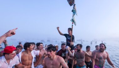 Nick White is carried to the beach after winning the Greasy Pole Contest at Pavilion Beach on June 29.