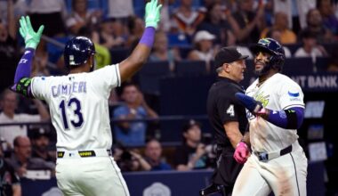 Tampa Bay Rays' Junior Caminero (13) and Yandy Díaz celebrate after Diaz scores on a double by Jonathan Aranda, not pictured, during the seventh inning of a baseball game against the Arizona Diamondbacks Friday, June 26, 2026, in St. Petersburg, Fla. (AP Photo/Jason Behnken)