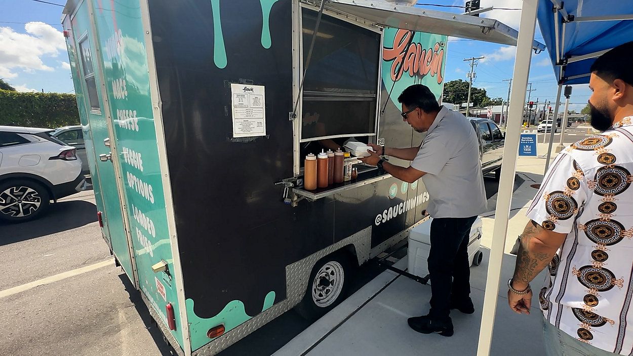 Customers line up at Saucin Wings food truck in Tampa. (Spectrum News)
