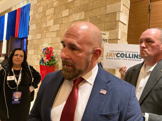 Lt. Gov. Jay Collins, a candidate for the Republican nomination for governor, speaks to reporters at the Republican Party of Florida's Sunshine State Showdown at the Seminole Hard Rock Hotel & Casino in Hollywood on Saturday, June 27, 2026. Watching, at left, is Mery Lopez-Palma, a Republican candidate for state representative in Broward. (Anthony Man/South Florida Sun Sentinel)