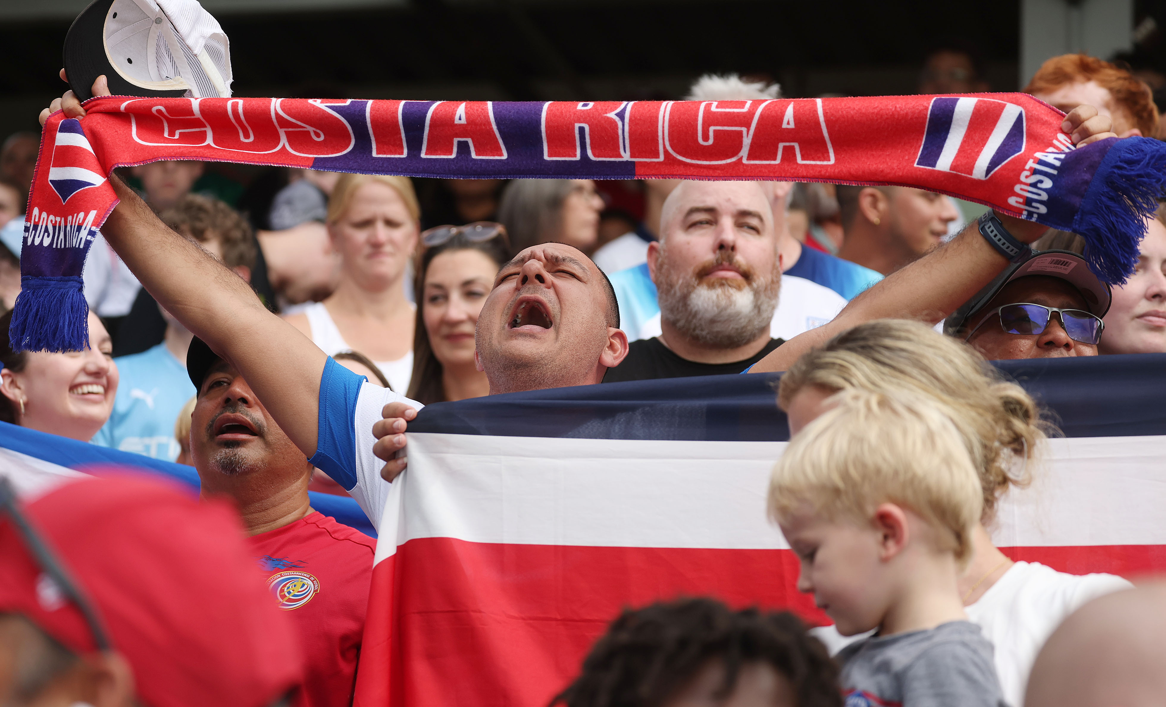 A Costa Rica fan sings the national anthem before the...