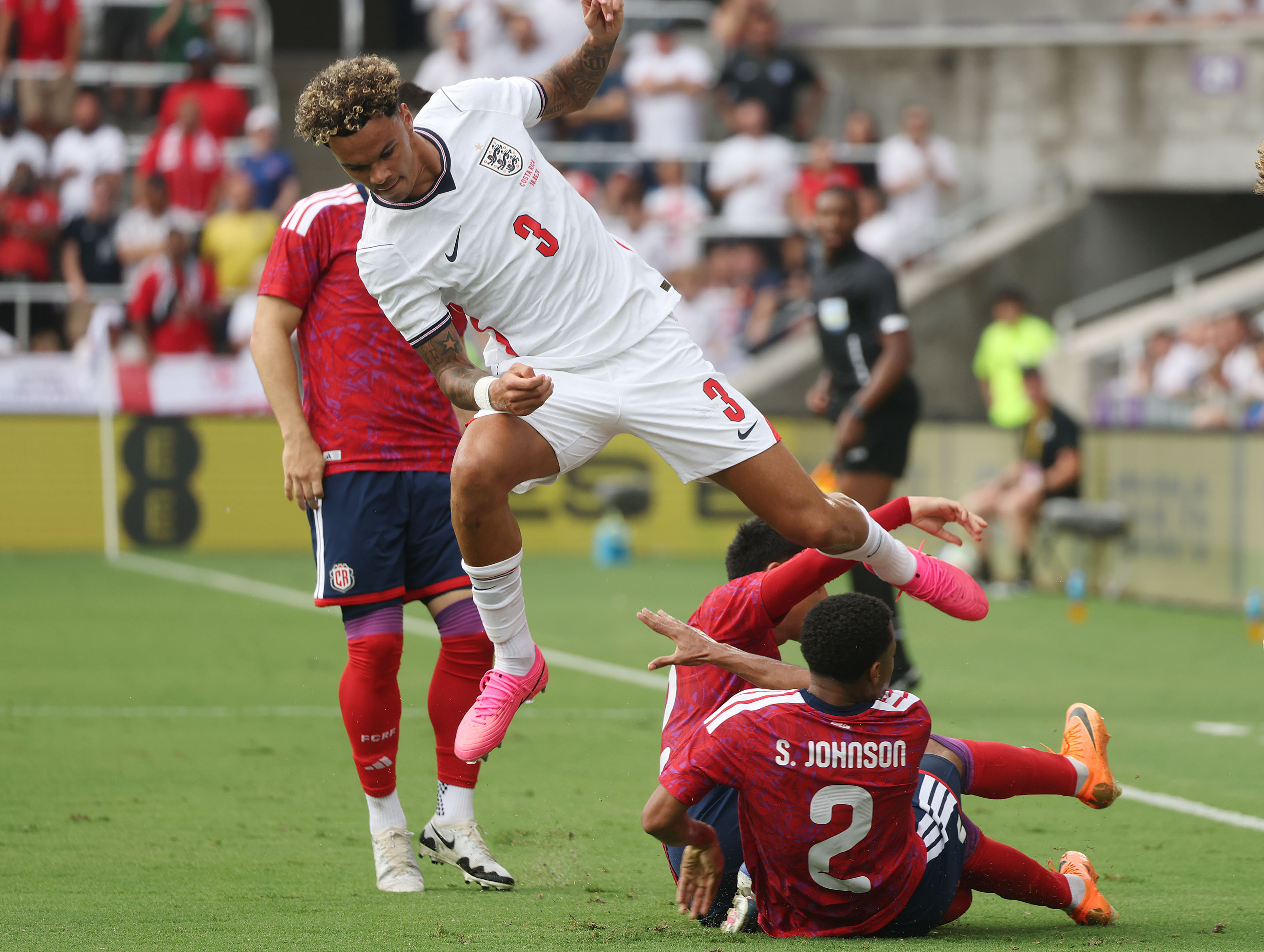 England player Nico O'Reilly (3) leaps over Costa Rica player...