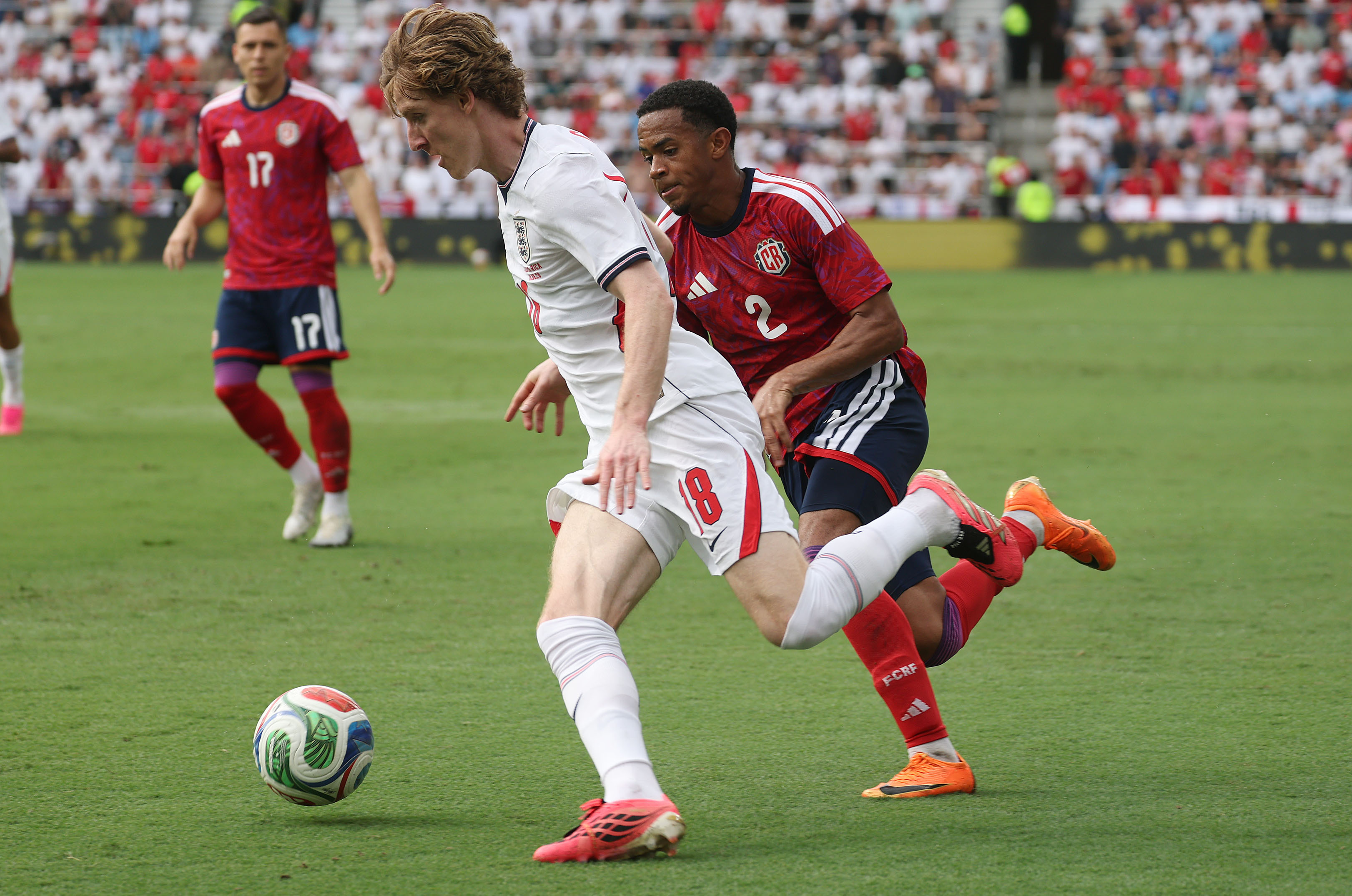 England player Anthony Gordon (18) moves the ball past Costa...