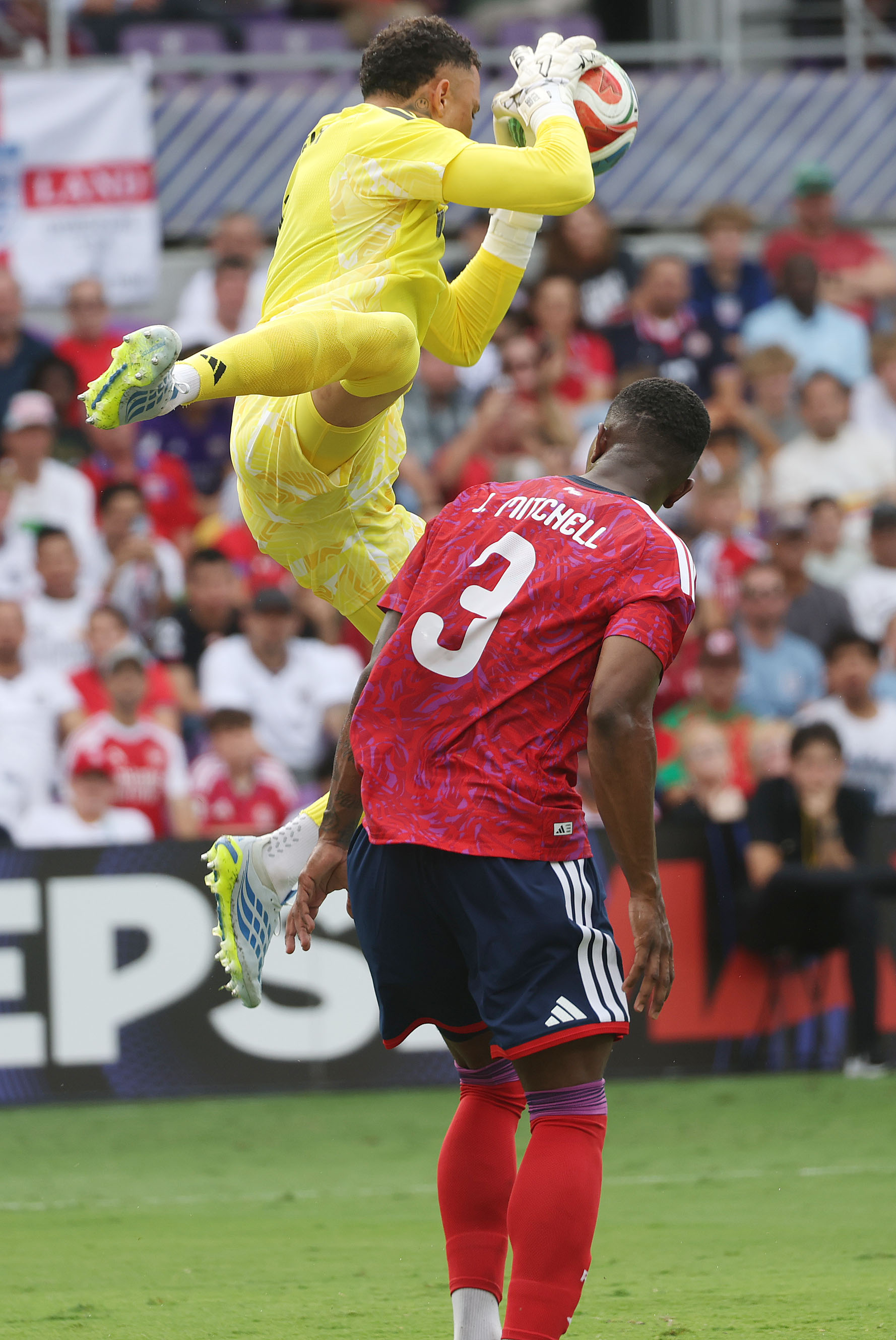 Costa Rica goalkeeper Patrick Gilmar Sequeria Mejias (top) leaps to...