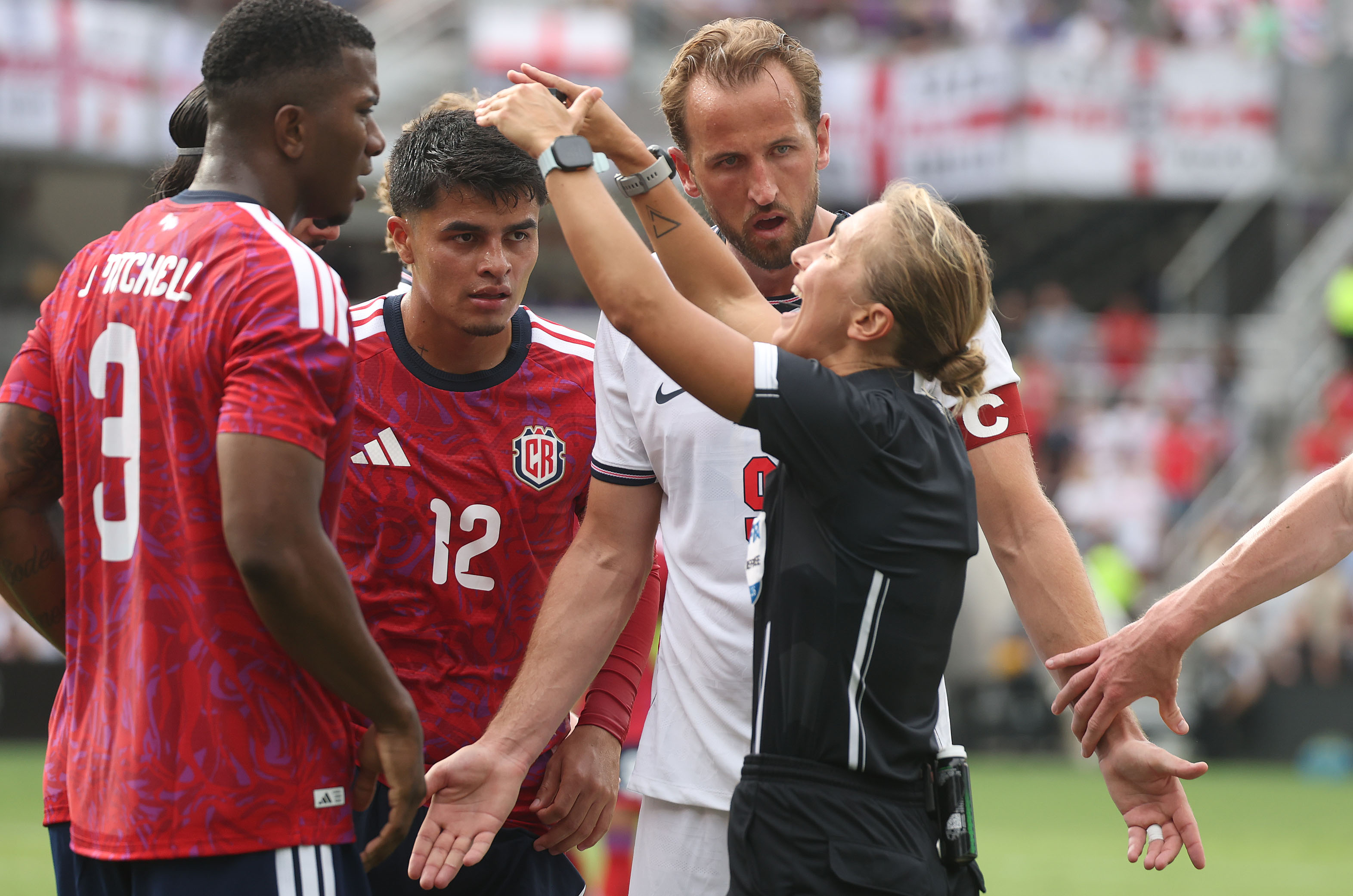 England player Harry Kane (9) argues with a game official...