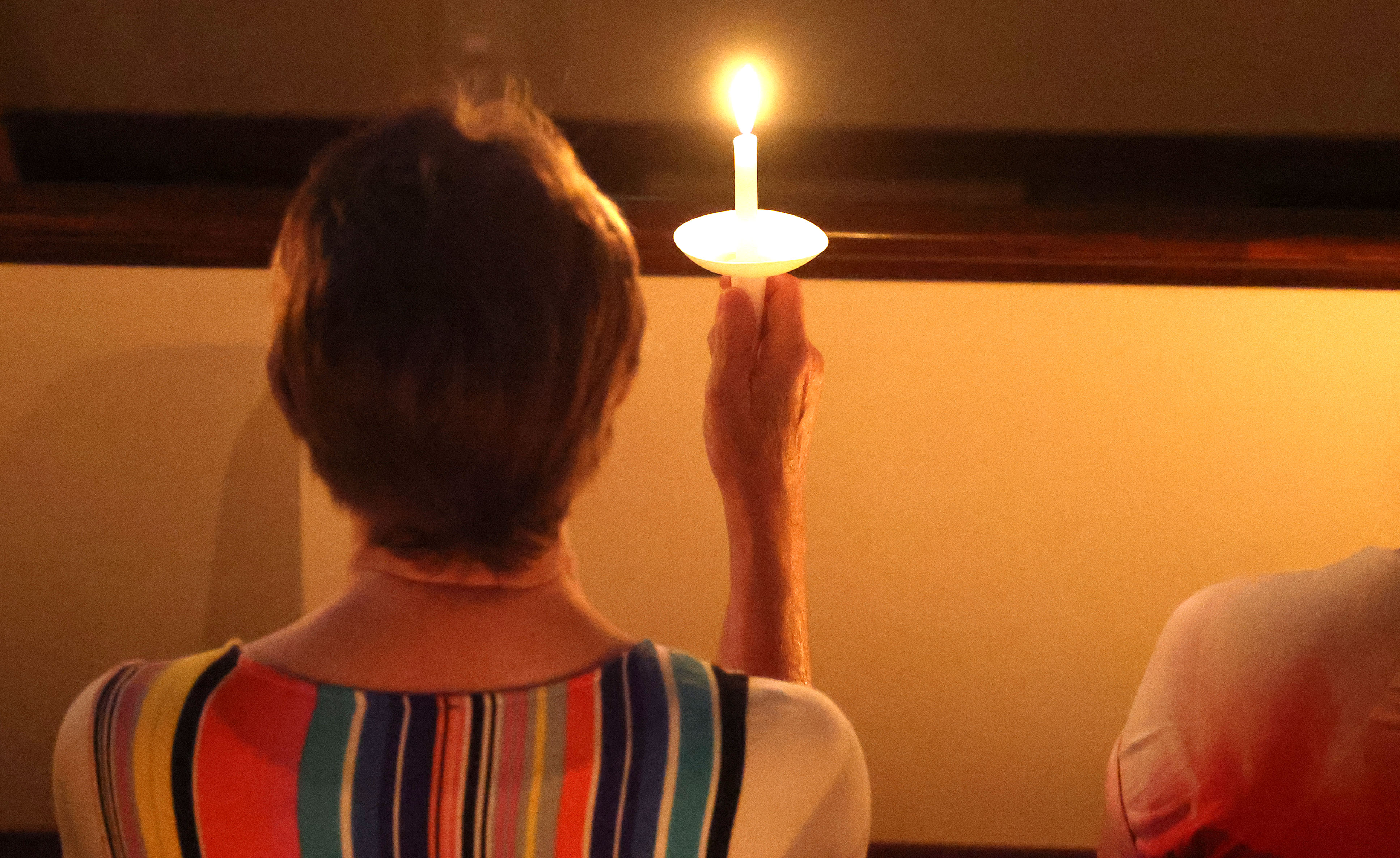 A candle is held aloft during the 2026 Pulse Day...