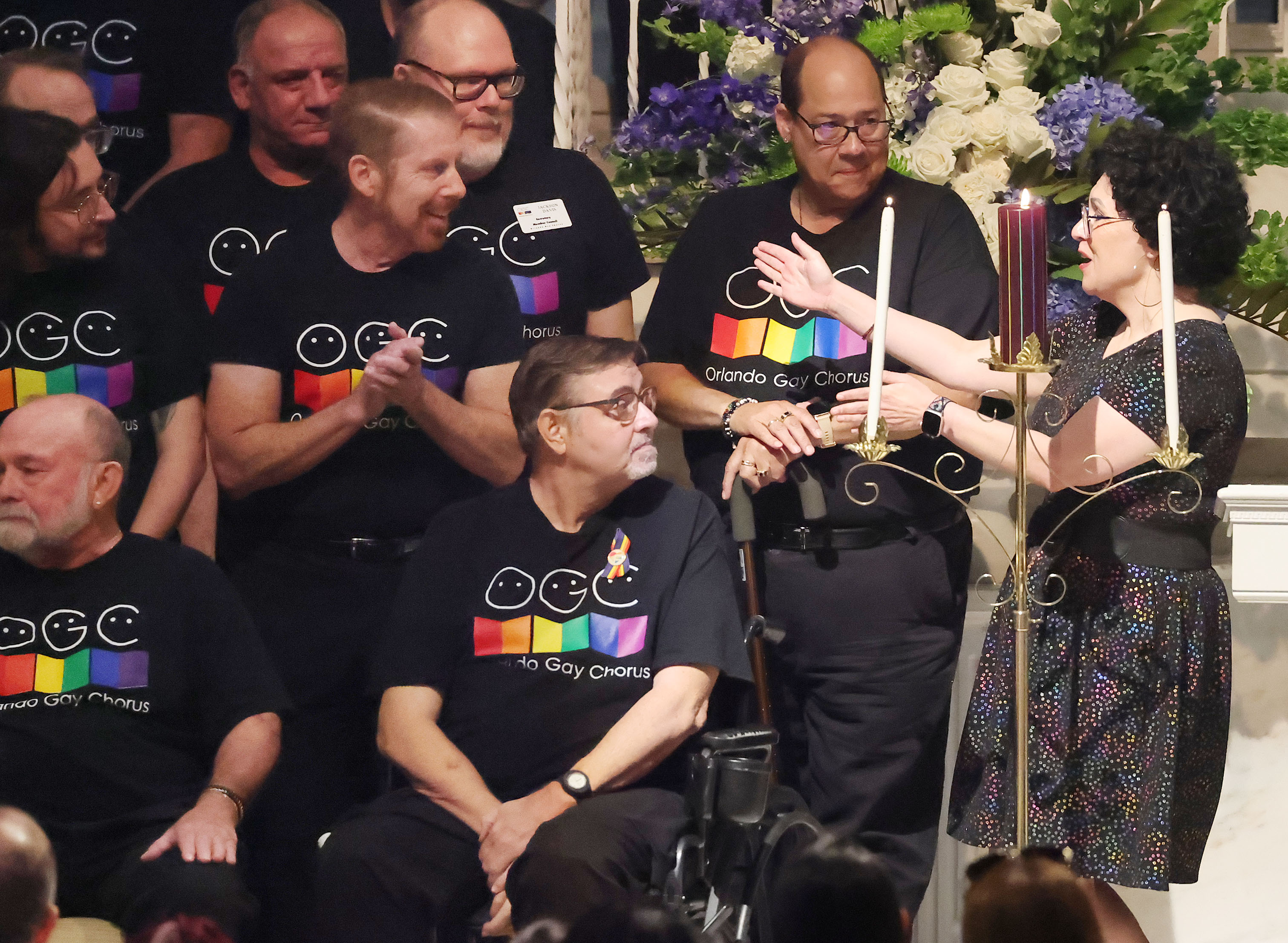 Emcee Tatiana Quiroga (right) reaches out to embrace members of...