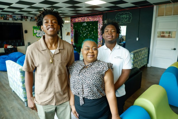 Shakeyia Hall and her sons, Timothee Jorcius, left, and Tyquan Hall, in the Hang Out space at Parramore Kidz Zone in Orlando on Monday, June 1, 2026. The teens have grown up utilizing the community center's after-school activities and summer camps since kindergarten. (Rich Pope/Orlando Sentinel)