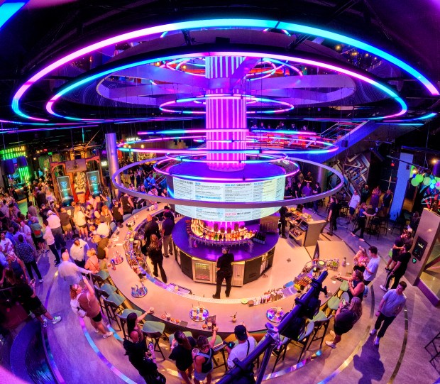 A view of the towering Level99 bar during the ceremonial opening of the 42,000-square-foot social-gaming venue at Disney Springs, Thursday, June 25, 2026. The puzzle-centric attraction features more than 60 physical, mental and locked-room challenges. Opening to the public June 29, Level 99 serves a full menu of bites, cocktails and beers. (Joe Burbank/Orlando Sentinel)