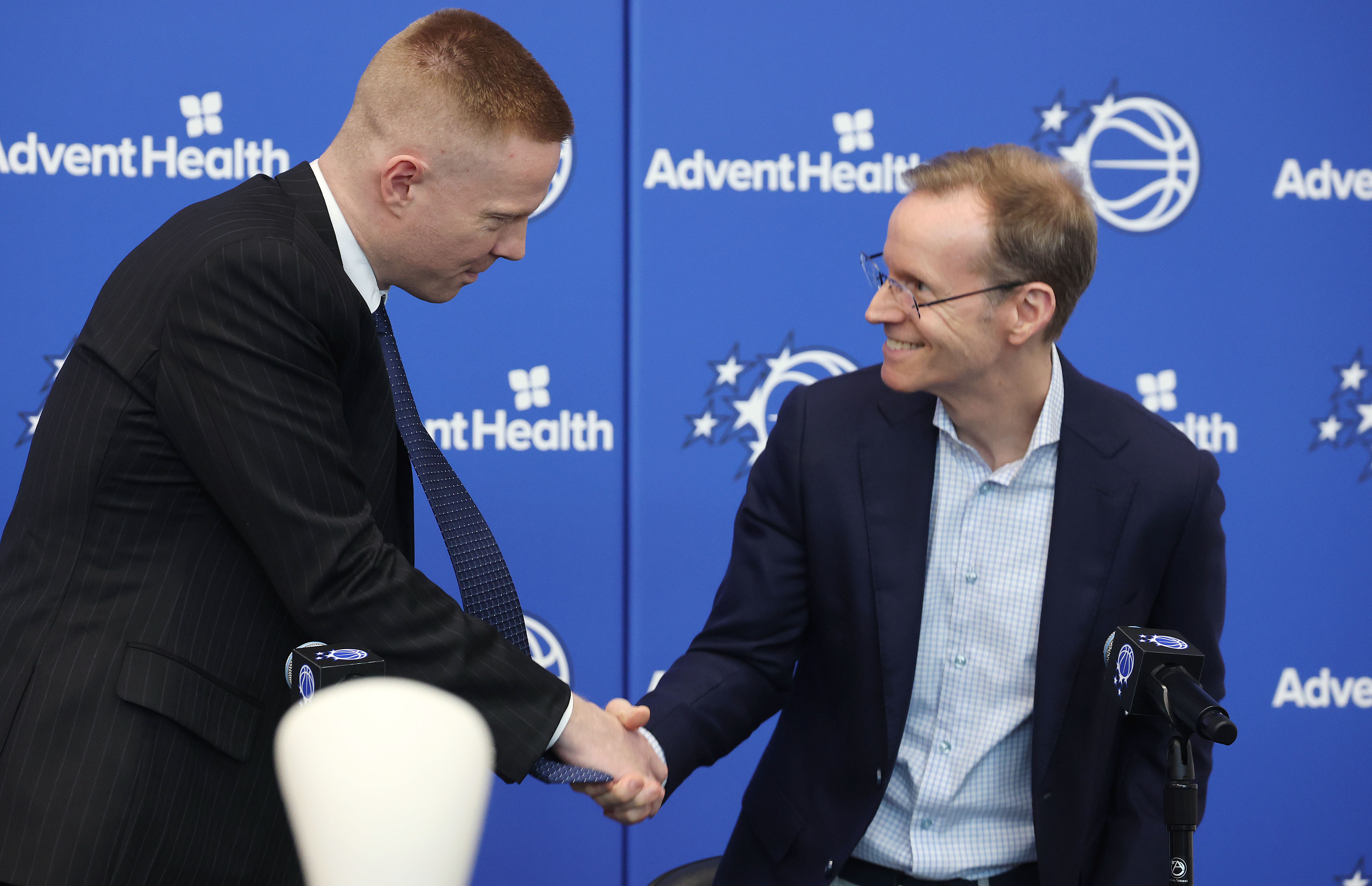 New Orlando Magic head coach Sean Sweeney, left, and Magic...