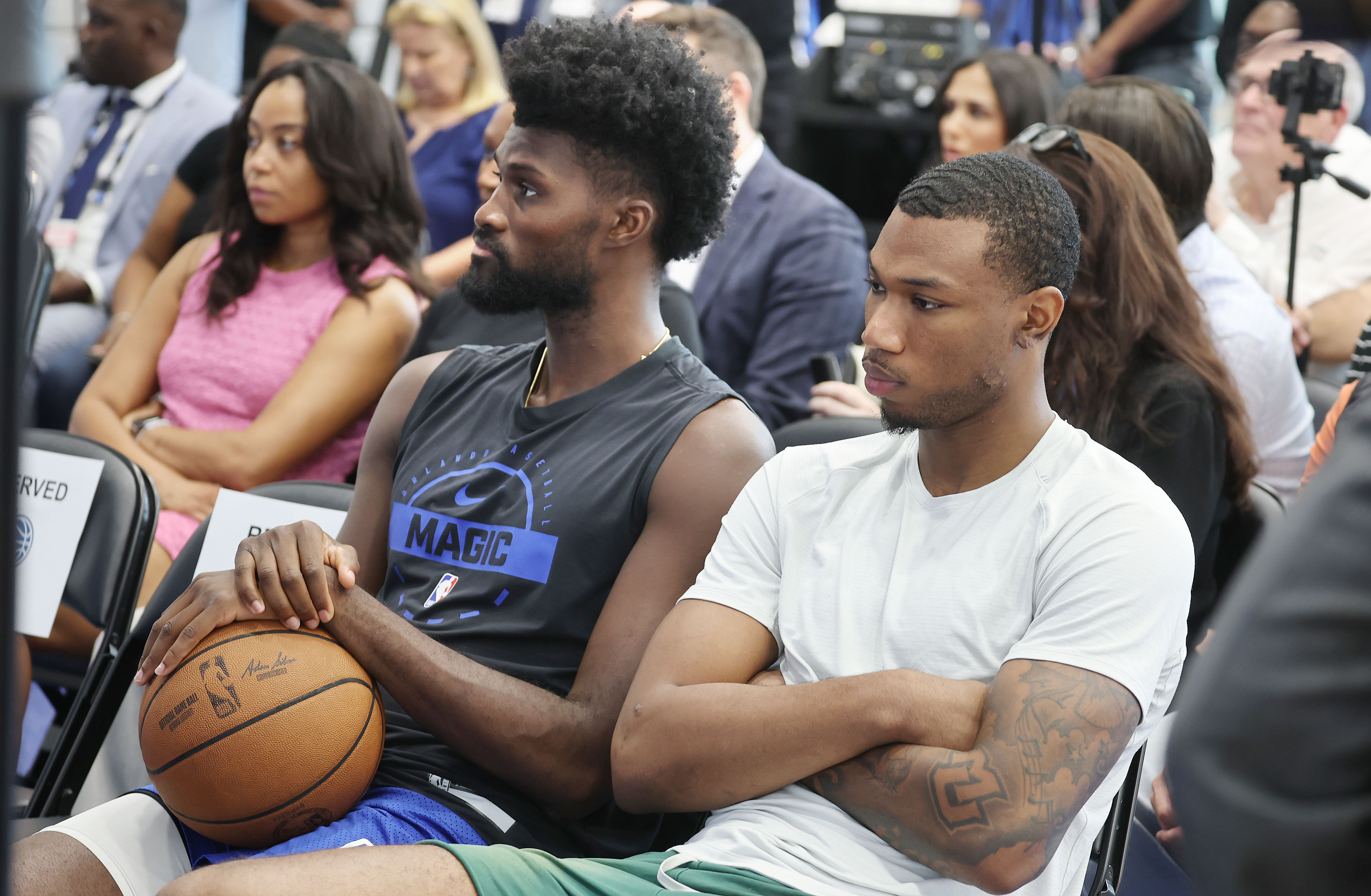 Orlando Magic forwards Jonathan Isaac, left, and Jamal Cain watch...