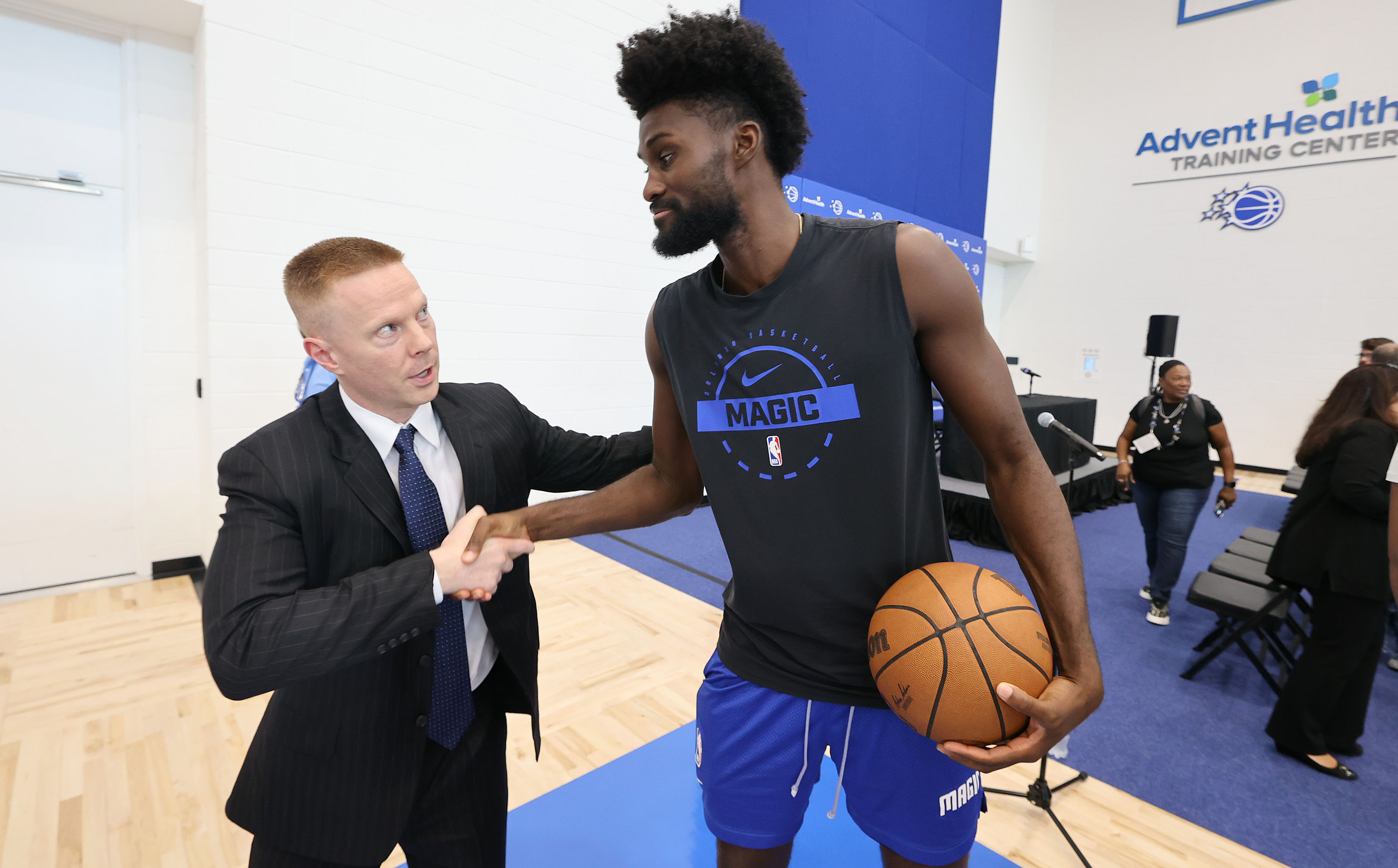 New Orlando Magic head coach Sean Sweeney, left, greets Magic...