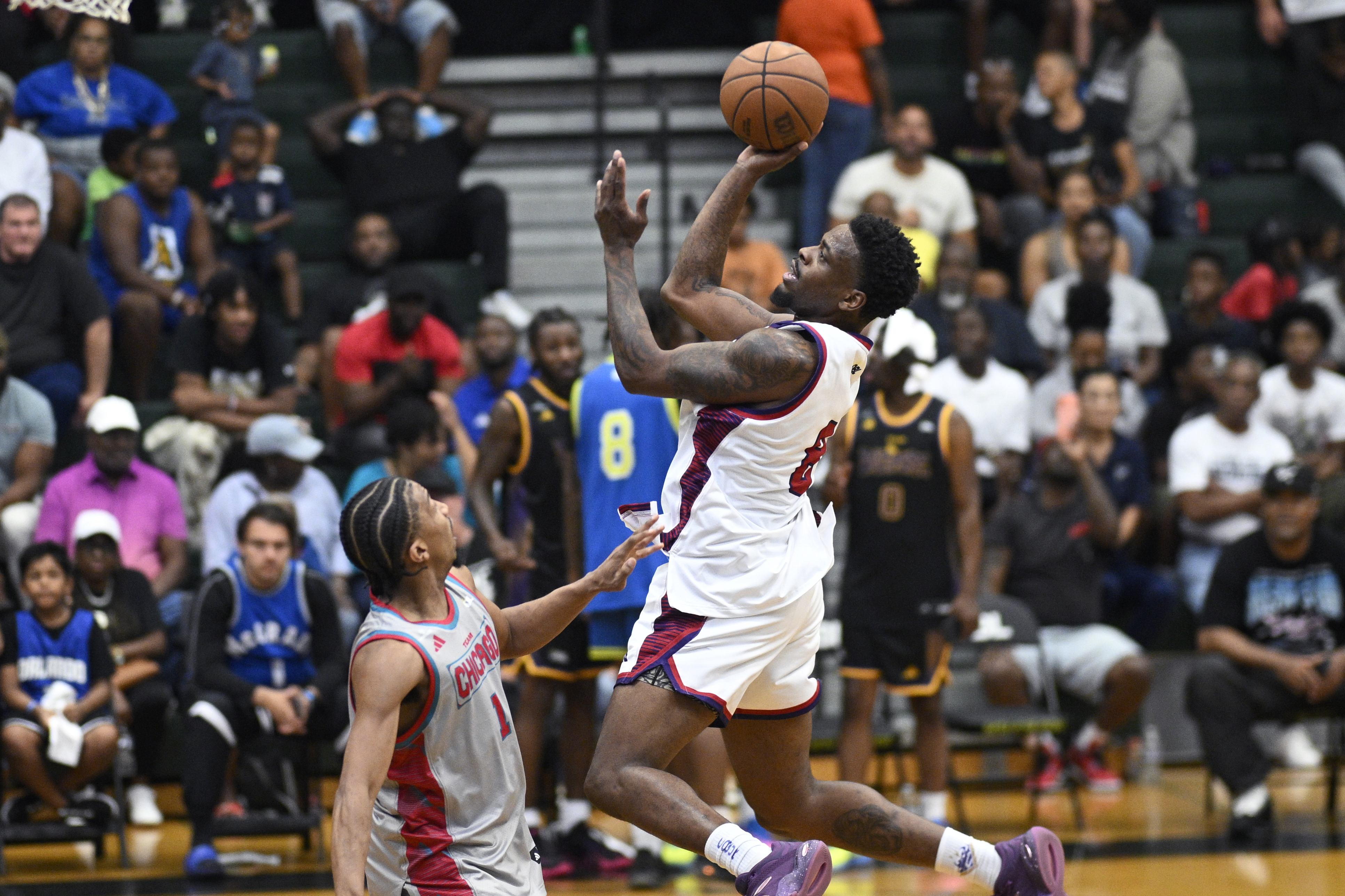 Team Atlantaâs Malik âBamBamâ Dunbar, right, goes up to shoot...