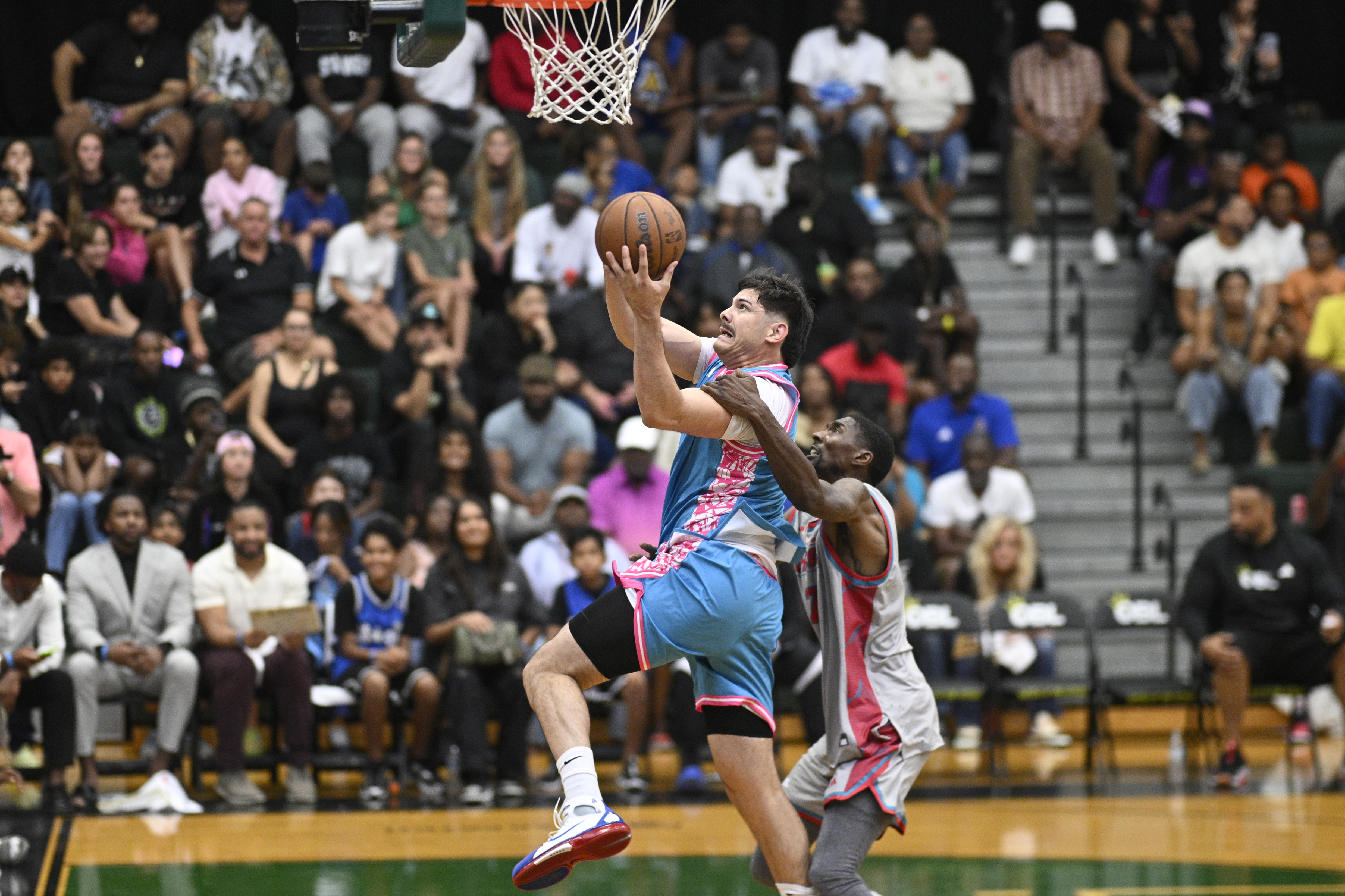 Team Miamiâs Josmel â305Bucketsâ Martinez, left, is fouled by Chicagoâs...