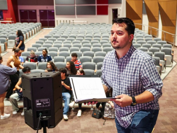 University High School Theater Director Alex Mendez takes the stage while directing the Orange County Public Schools production of "In the Heights" at Edgewater High School, Thursday, June 18, 2026. More than 90 high school students from across the district are involved with producing the show as cast, crew, and orchestra. The show runs June 26, 27 & 28. (Joe Burbank/Orlando Sentinel)