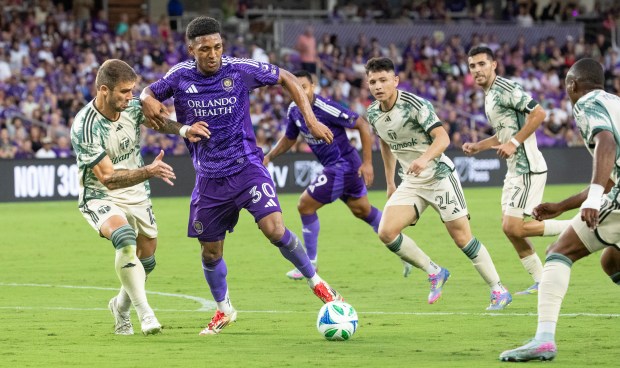 Orlando City defender Alex Freeman (30) dribbles the ball through the Portland Timbers defenders during the match at the Inter & Co Stadium in Orlando on May 24, 2025. (Orlando Sentinel file)