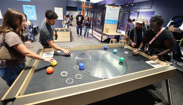 Guests enjoy a game during Orlando Science Center's Science Night Live on Saturday, May 30, 2026. The event was for ages 18 and to enjoy optical illusions, board games, trivia, guest experts, art displays, exhibits, telescopes and more. (Stephen M. Dowell/Orlando Sentinel)