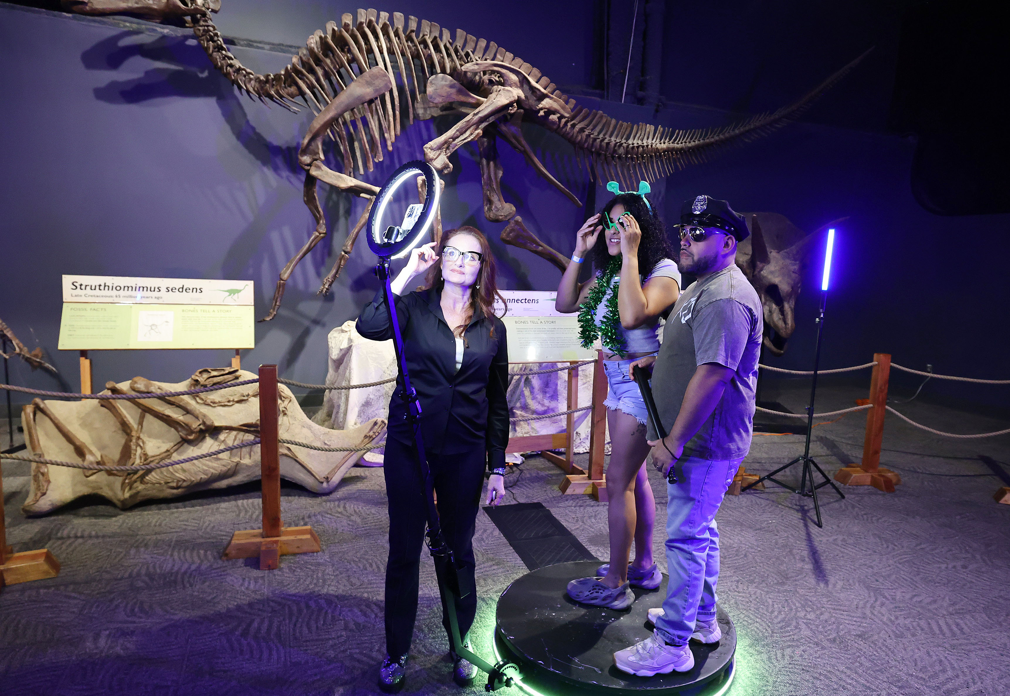 Guests enjoy a photo booth under a didnosaur skeleton during...