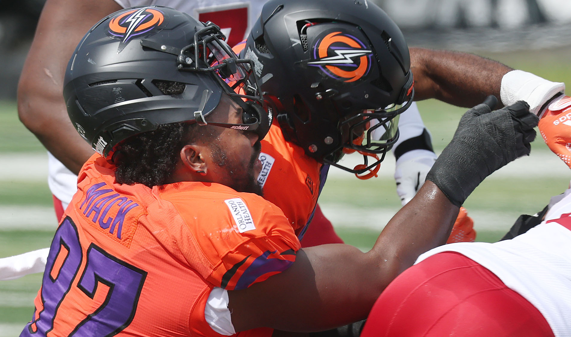 Storm defensive lineman Isaiah Mack loses his helmet in a...