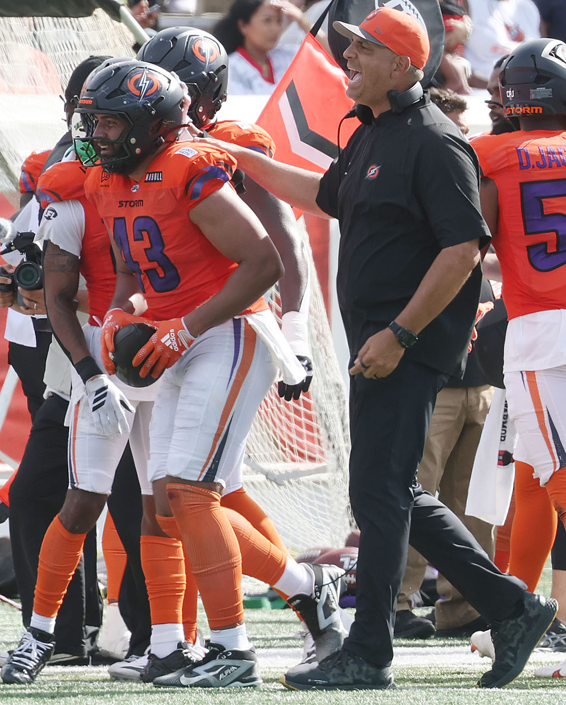 Storm head coach Anthony Becht congratulates linebacker Kana'i Mauga (43)...