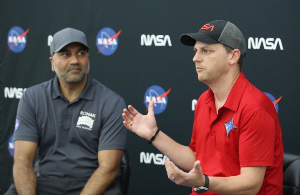 Neil Patel, left, an engineer at the NASA Goddard Space Flight Center, and Chris Reid, with NASA's Launch Services Program, discuss the logistics of the transport of the Nancy Grace Roman Space Telescope, which arrived on the agency's Pegasus barge to Kennedy Space Center on Sunday, June 21, 2026. (Richard Tribou/Orlando Sentinel)